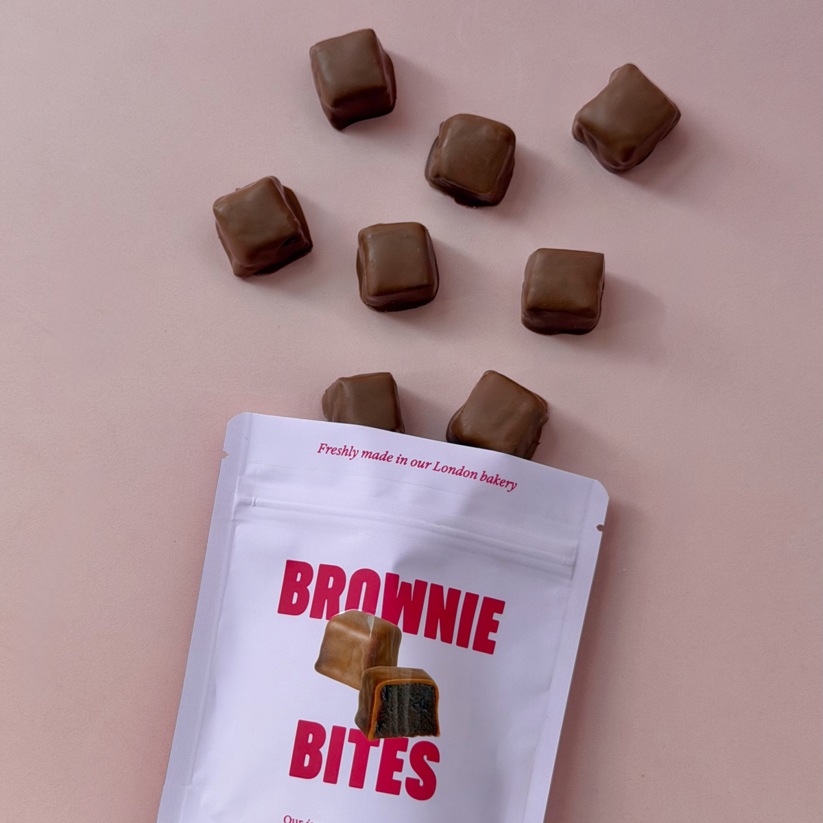 Milk chocolate coated brownie bites spilling out of a Brownie Bites pouch