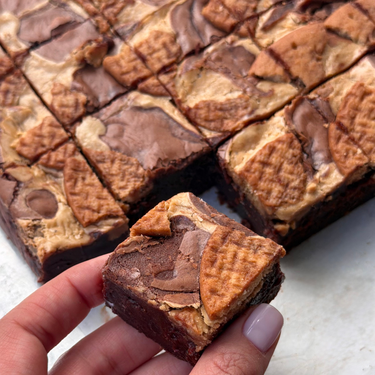 A tray of Earl Grey tea and biscuit brownies, each topped with a biscuit