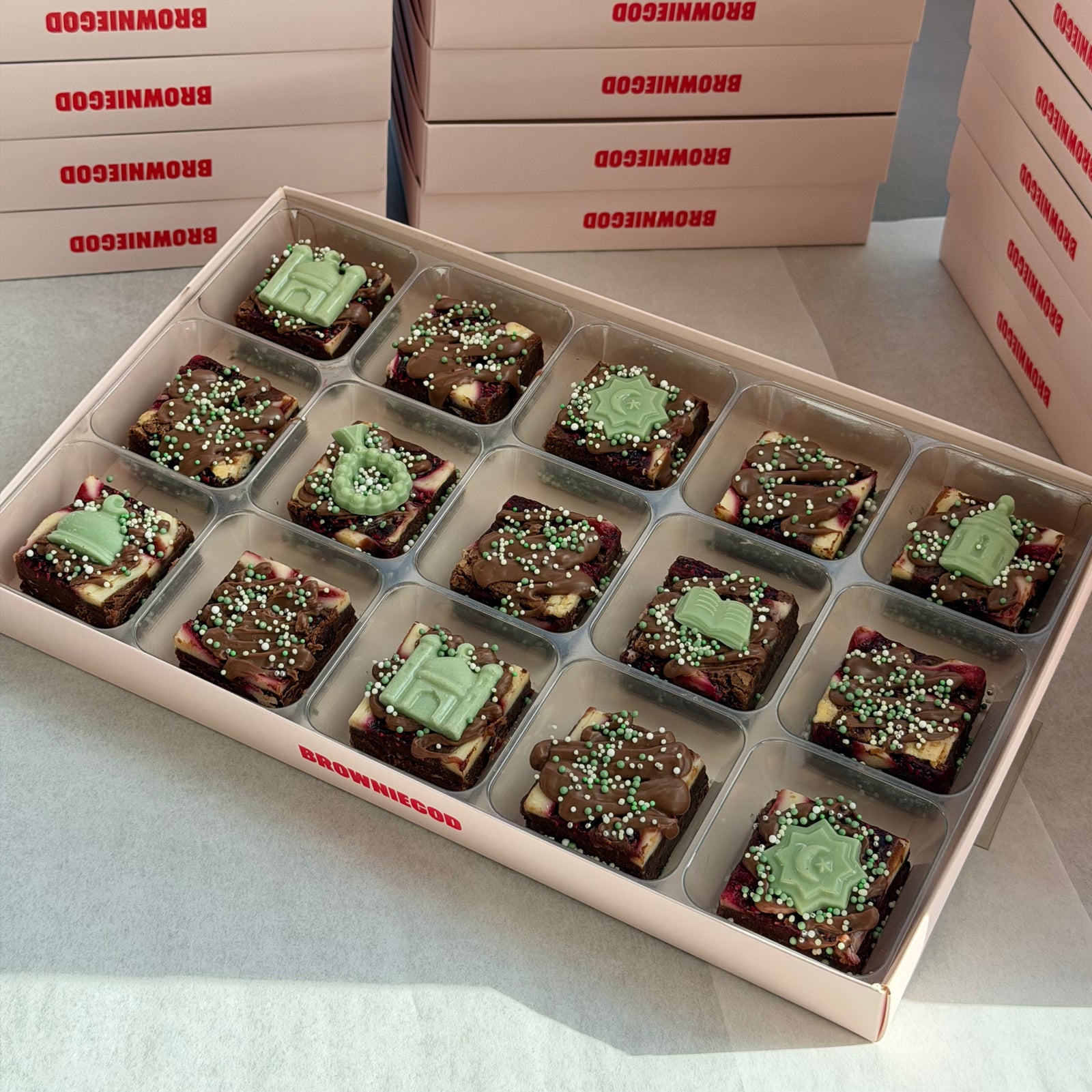 Box of 15 Ramadan mini brownies with green chocolate mosque, lantern and star toppers, with Browniegod boxes stacked behind