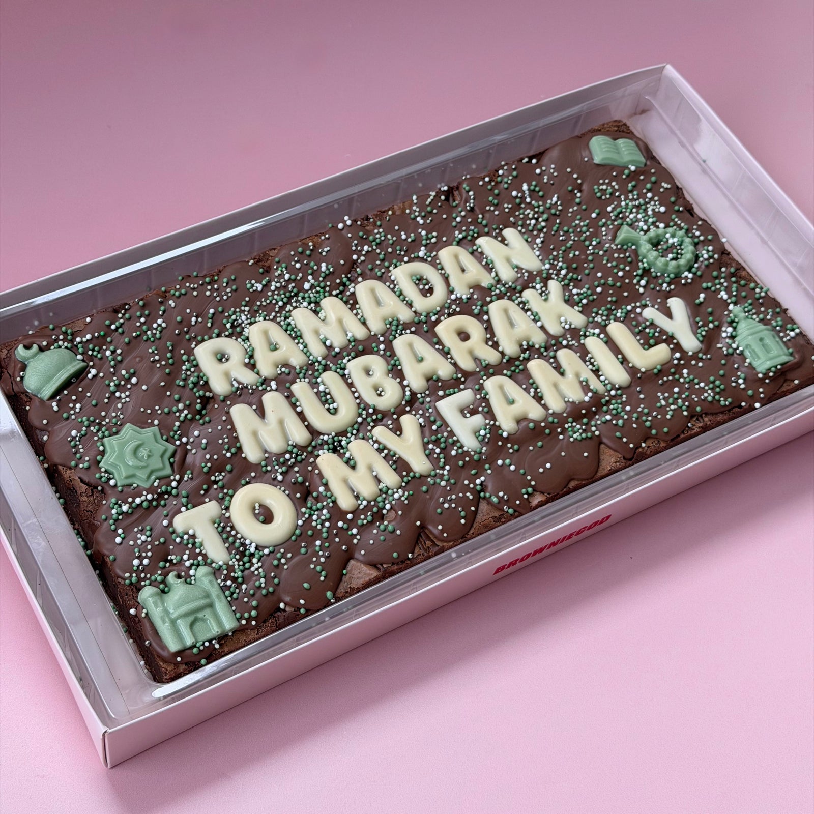 Long Ramadan brownie slab reading "Ramadan Mubarak to my family" in white chocolate letters with green mosque and lantern toppers