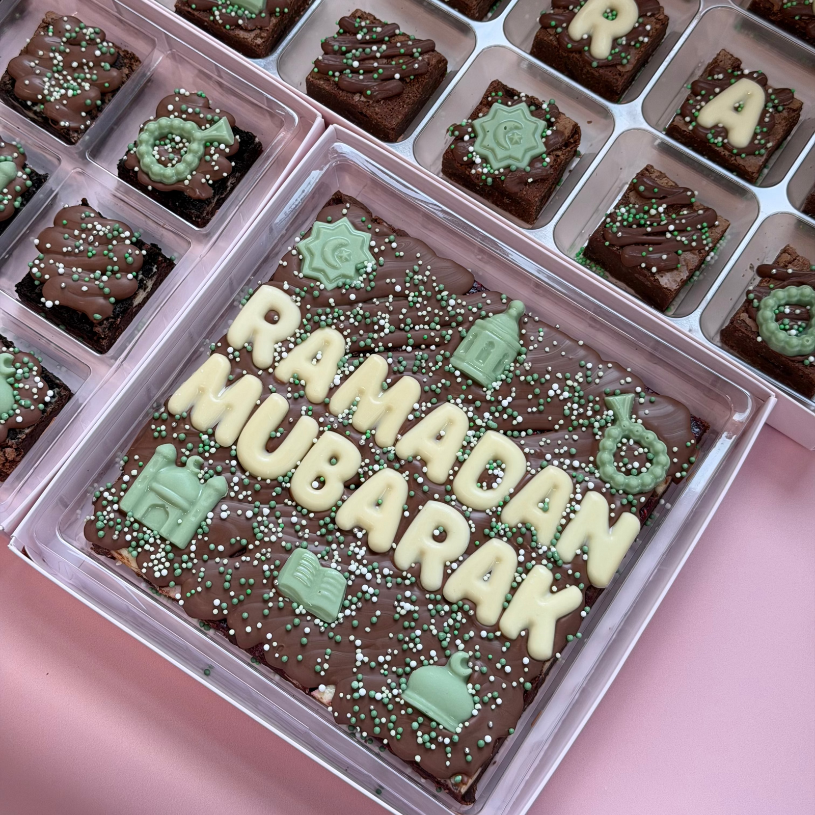 Brownie slab reading "Ramadan Mubarak" in white chocolate letters with green mosque, star and lantern toppers