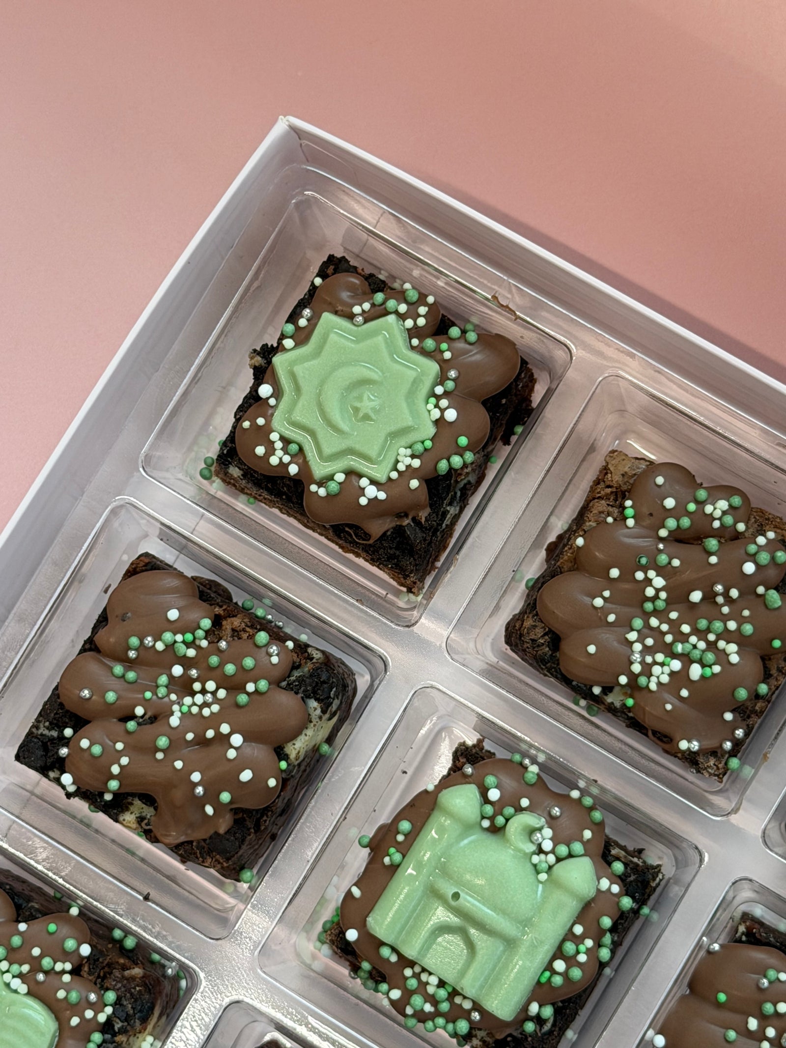 Ramadan mini brownies in a clear tray topped with green chocolate mosque and crescent star toppers and green sprinkles
