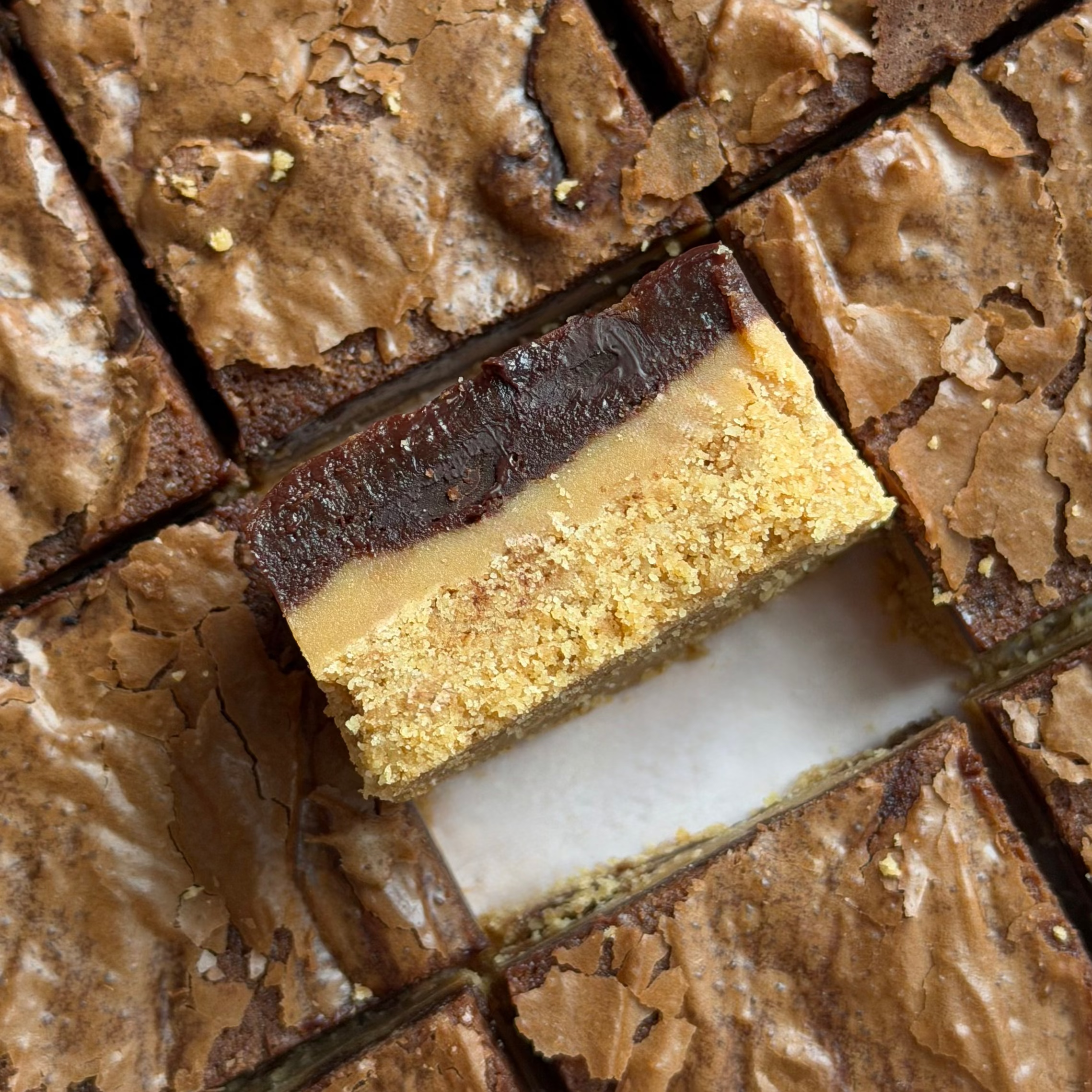 Close-up of twix layered brownie with caramel and biscuits